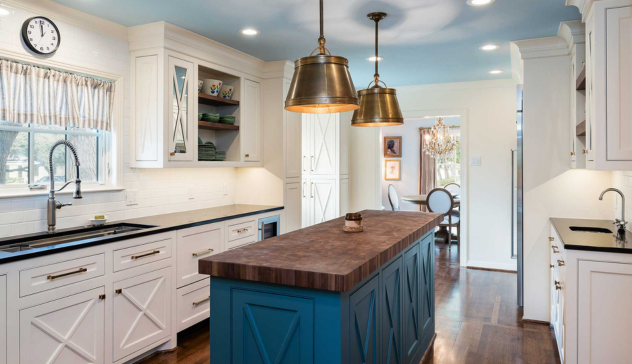 Butcher Block Countertops Butcher block island surrounded by shaker cabinetry.