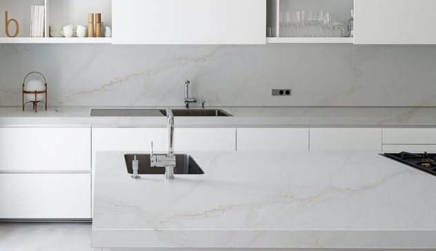 Close-up of a smooth, light-toned quartz countertop with subtle veining.