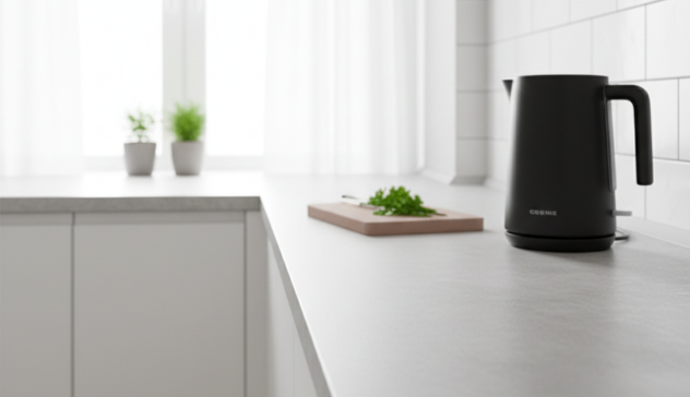 A compact kitchen featuring laminate countertops with a stone-look pattern, styled simply with a kettle and cutting board. The surface looks smooth, clean, and practical, emphasizing easy maintenance and affordability without sacrificing style.