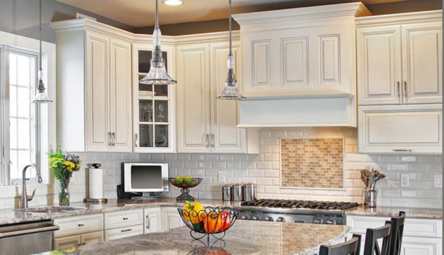 A photo showing a craftsman fitting MDF or poplar crown molding along the upper kitchen cabinets. Include subtle paint details and layered trims to suggest a high-end custom look on a budget.